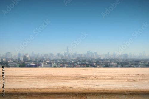wooden terrace with cityscape background