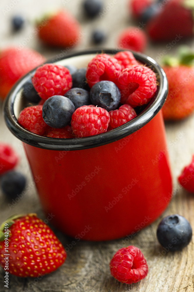 Summer berries in red mug Summer berries in red mug