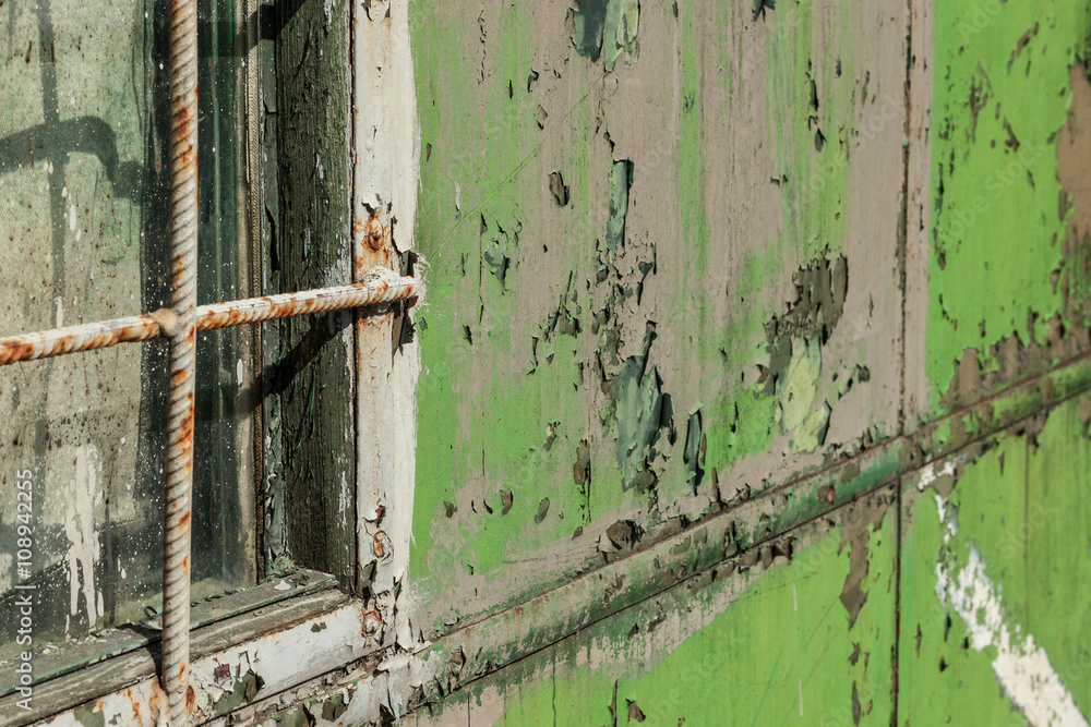 old construction trailer.grunge background.shelled green paint 