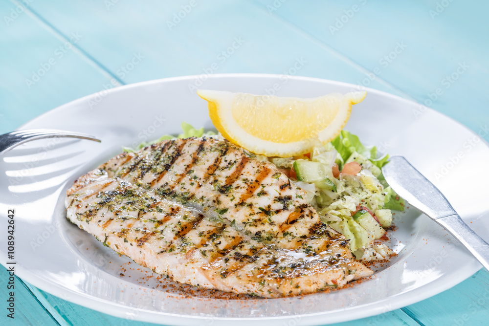 salmon fillet on the grill serve fresh salad and lemon salmon fillet on the grill serve fresh salad and lemon