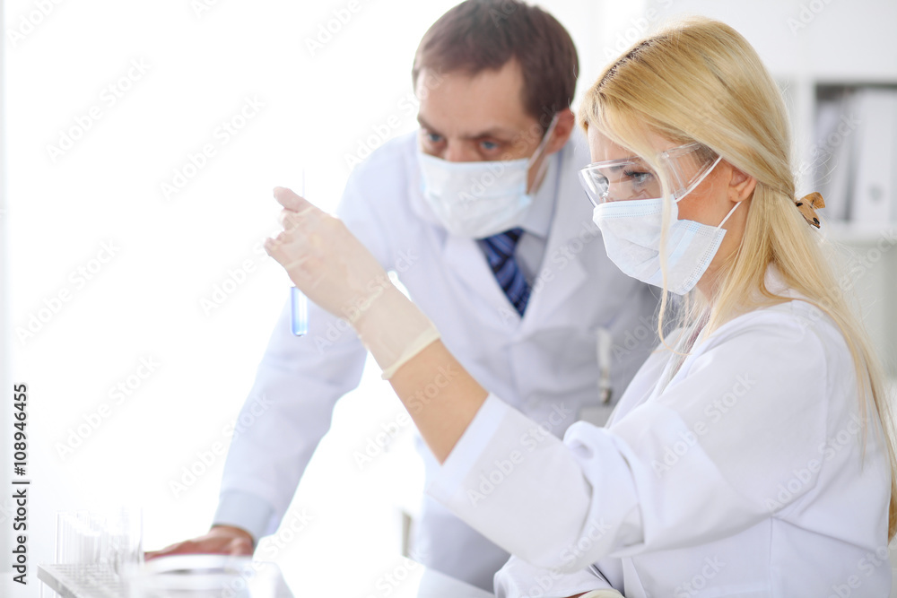 Scientific research team with clear solution in laboratory Scientific research team with clear solution in laboratory