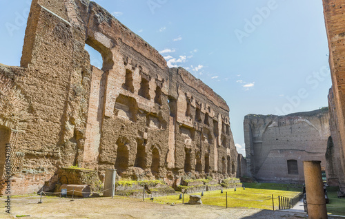 Panoramic view on old swimming pool ( or Natatio ) in the scenic ruins of ancient Roman Baths of Caracalla ( Thermae Antoninianae ),at summer sunny day.Built between AD 212 - 217. Rome. Italy. Europe. photo