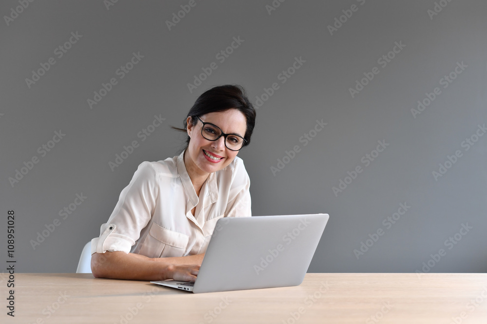 Attractive woman working on laptop computer Attractive woman working on laptop computer
