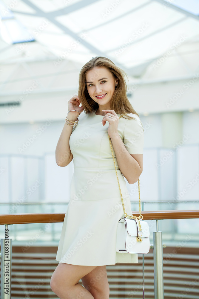 Beautiful young woman walks in the shop Beautiful young woman walks in the shop