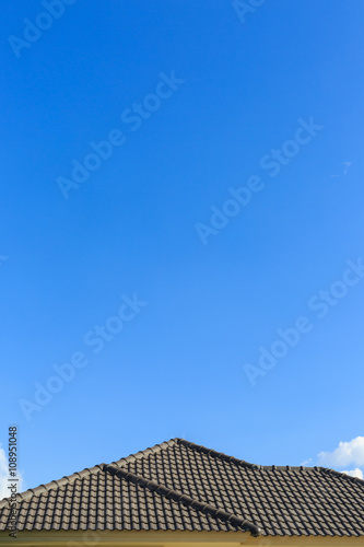 black tile roof on a new house with clear blue sky background