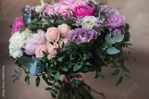 Beautiful bright wedding bouquet of hydrangea  peonies and roses on a background of kraft paper