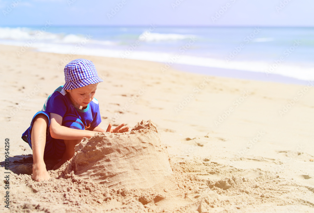 little boy play with sand on summer beach little boy play with sand on summer beach