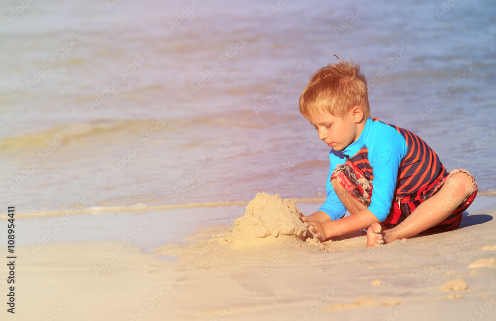 little boy play with sand on summer beach little boy play with sand on summer beach