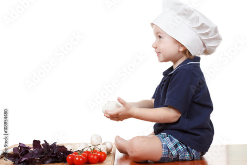 Little boy cook pizza. Clos...