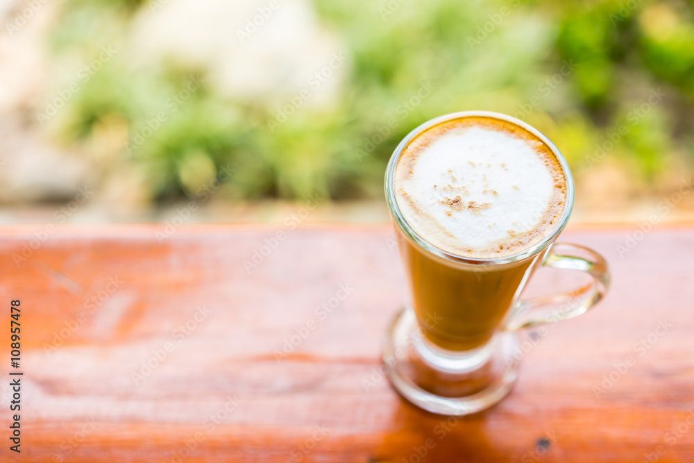 latte coffee cup on wooden table ,soft focus latte coffee cup on wooden table ,soft focus