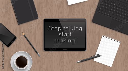 Quote Sop talking start making in tablet on office table. Top view workplace with gadget and stationery and coffee. Work inspiration quote.