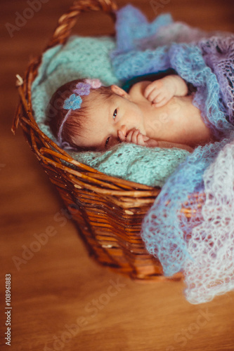 Lovely little baby in the knitted basket
