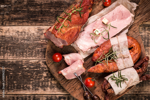 Antipasto catering platter with salami and meat on a wooden background photo