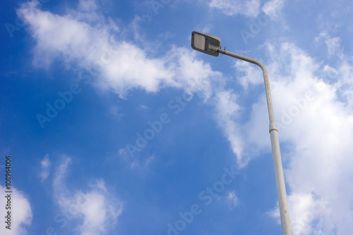 LED street lamp post on blue sky background with cloud
