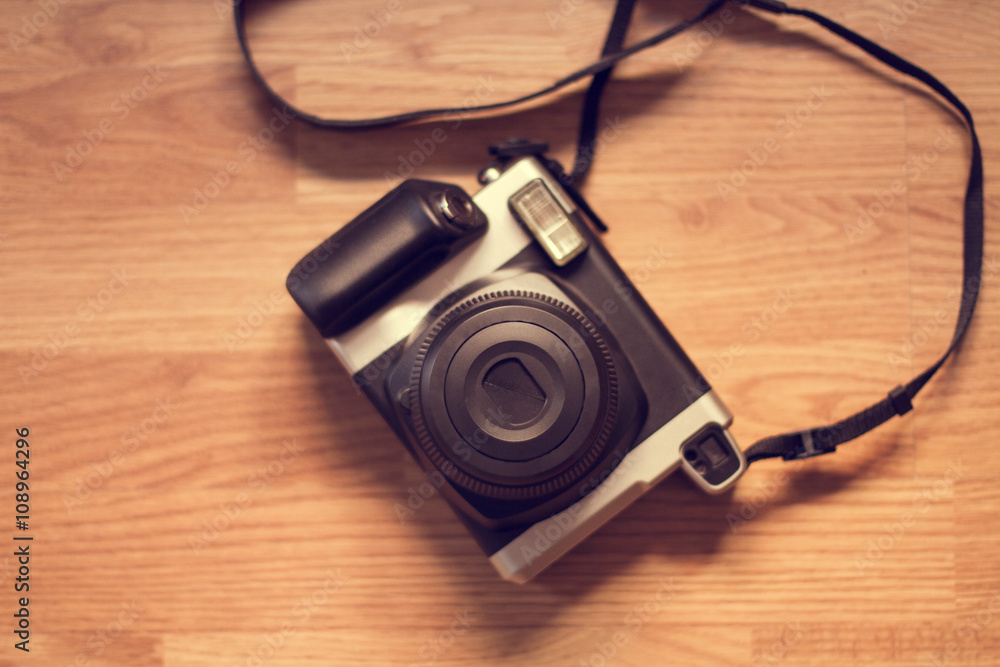 Cámara de fotos Polaroid. Vista superior sobre mesa de madera rústica