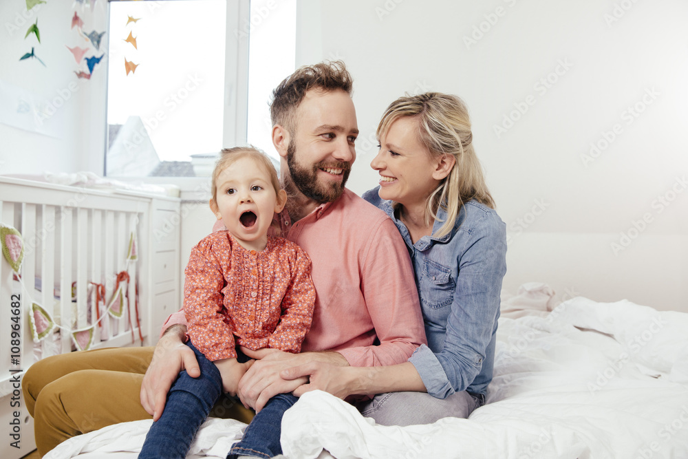 Portrait of happy family in their bedroom Portrait of happy family in their bedroom