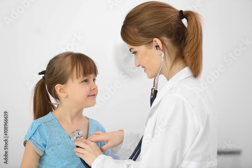 Doctor examining girl with ...