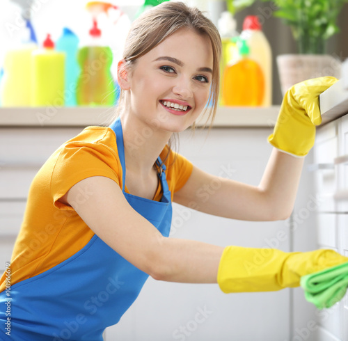 Cleaning concept. Woman washes an oven, close up