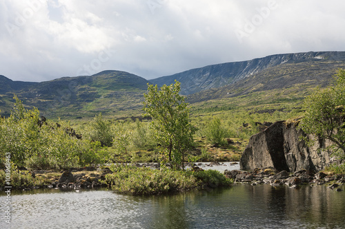 Severe beauty of Northern nature. Mountain lake in landscape of polar region.