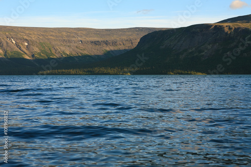 Severe beauty of Northern nature. Mountain lake in landscape of polar region. photo