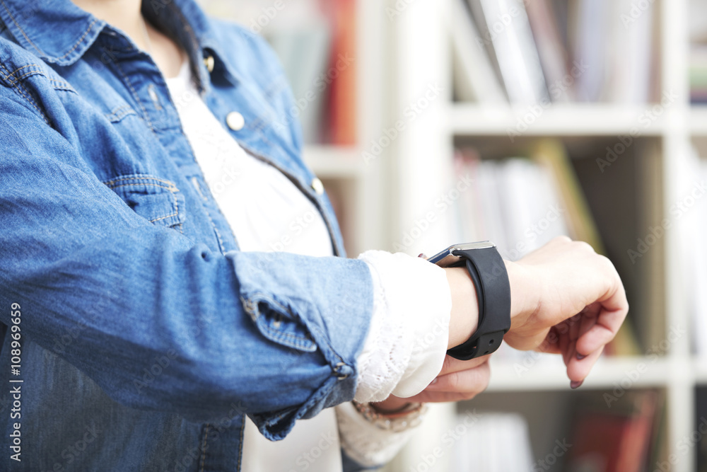 Woman wearing smartwatch, close-up Woman wearing smartwatch, close-up