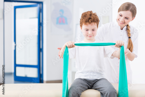 Boy and physical therapy in clinic