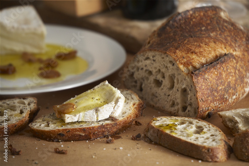 Tuscany country side table with bread,cheeses,wine,and olive oil.