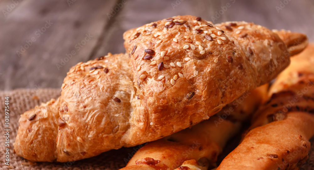 Fresh homemade small bread baguette with walnut and cheese on burlap Fresh homemade small bread baguette with walnut and cheese on burlap