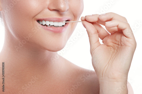 Female teeth and toothpick photo