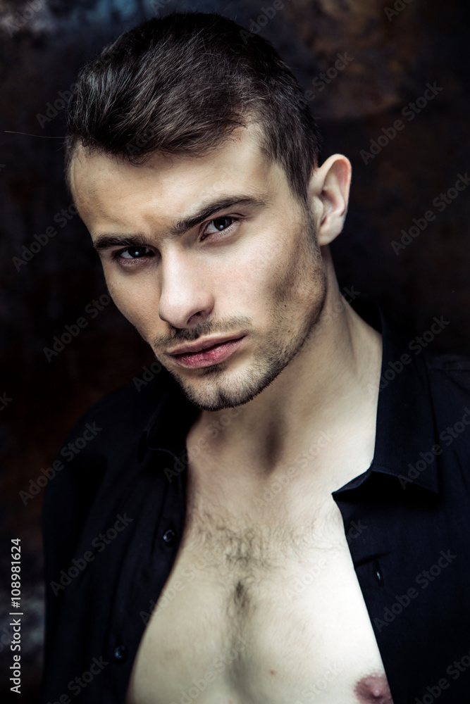 Fototapeta premium Close up portrit of Strong Athletic Man Fitness Model on dark background 