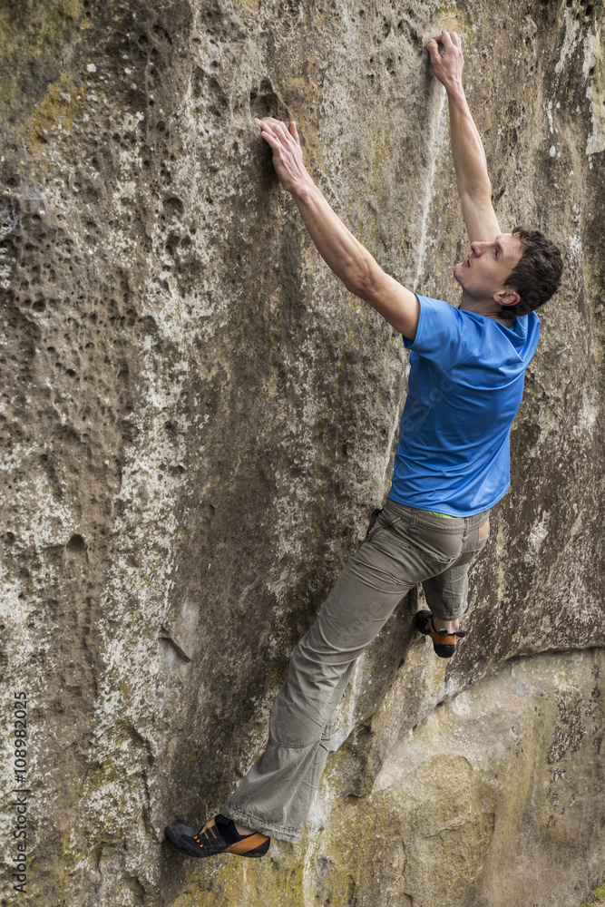 Athlete climbs on rock with rope. Athlete climbs on rock with rope.