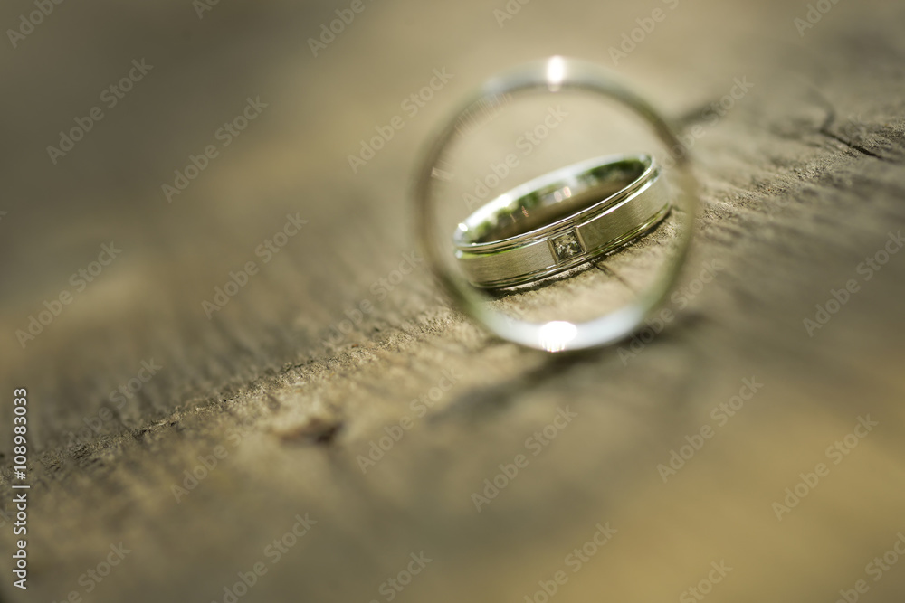 Gold wedding rings placed on a wooden texture Gold wedding rings placed on a wooden texture