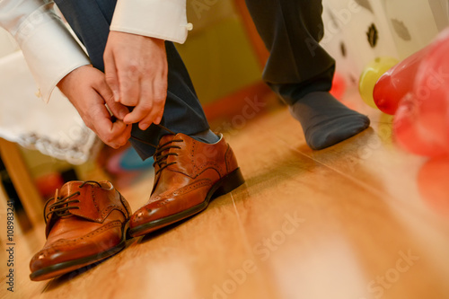 Man tied shoelace in natural light