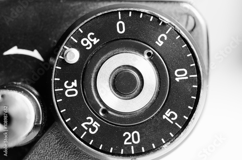 Fragment of old film camera. Top view of shutter button and the frame counter. Close up view. Macro. Selective focu. sVintage photo. Toning. photo