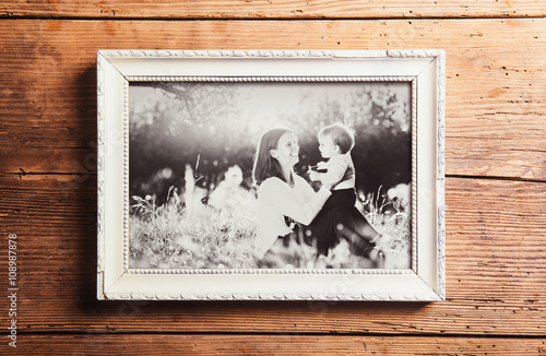 Mothers day composition. Picture frame. Wooden background. Studi