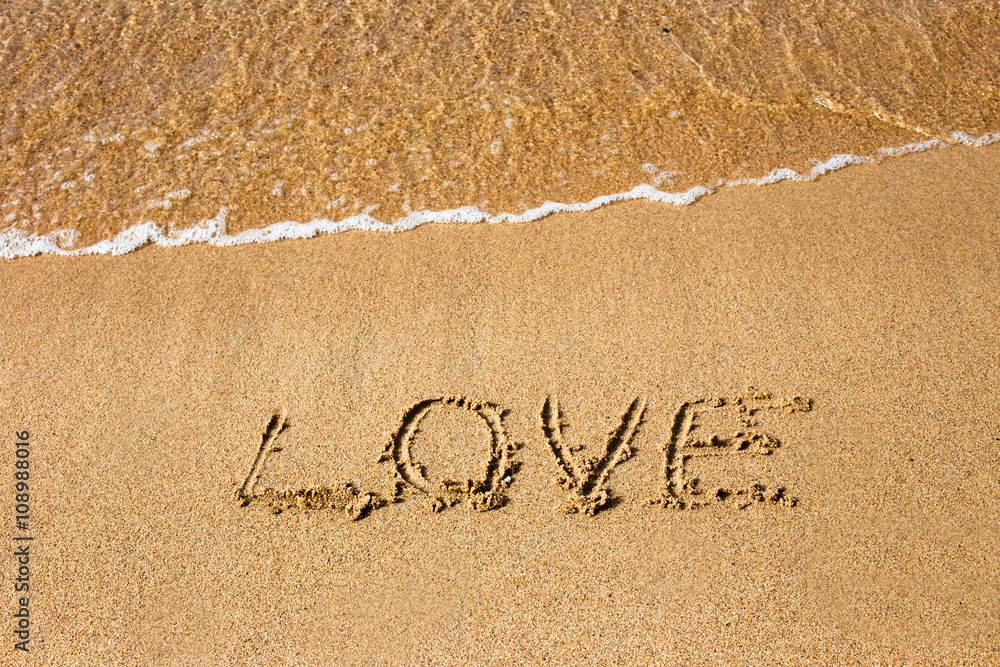 Fototapeta premium Inscription Love at the sand on the summer beach