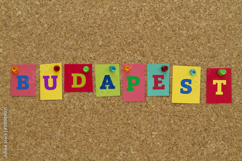 Budapest written on colorful notes pinned on cork board.