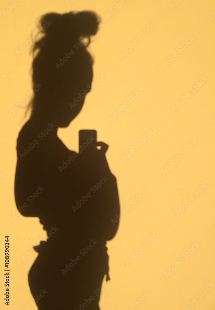silhouette of pregnant woman taking selfie