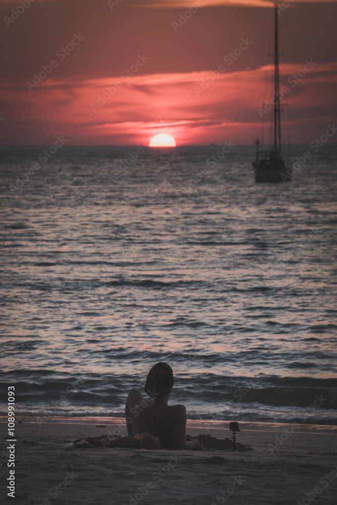 Woman Relax and watching sunset on beach Woman Relax and watching sunset on beach