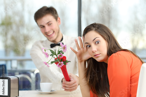 Woman rejecting a geek boy in a blind date