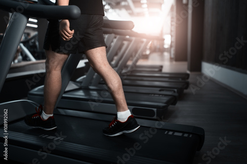 People walkingin machine treadmill at fitness gym club