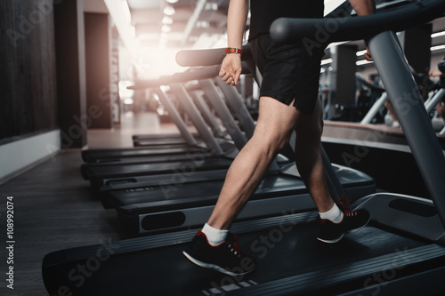 People walkingin machine treadmill at fitness gym club