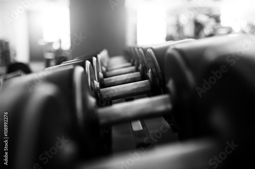Metal dumbbells lying on gym fitness club
