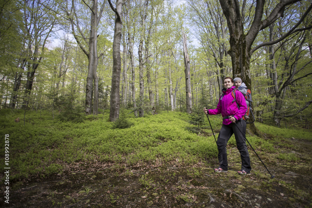 Mom walks in the forest with a child, a child in the children carry. Mom walks in the forest with a child, a child in the children carry.
