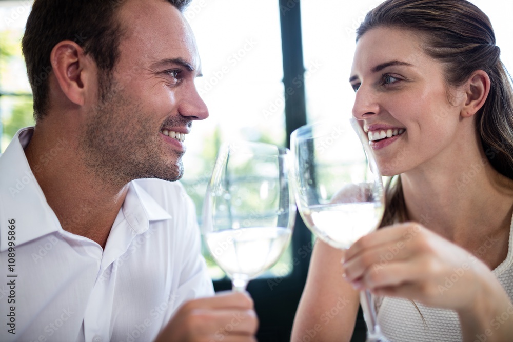 Couple toasting wine glasses at dining table Couple toasting wine glasses at dining table