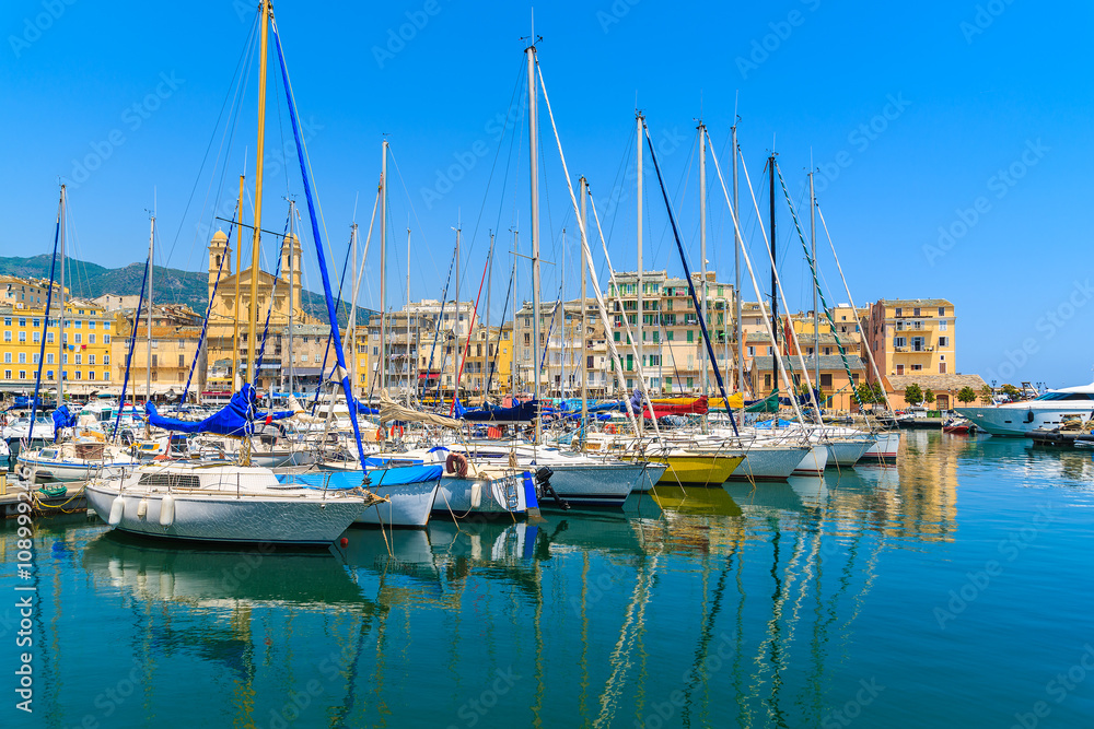 Sailing boats mooring in Bastia port on sunny summer day, Corsica island, France