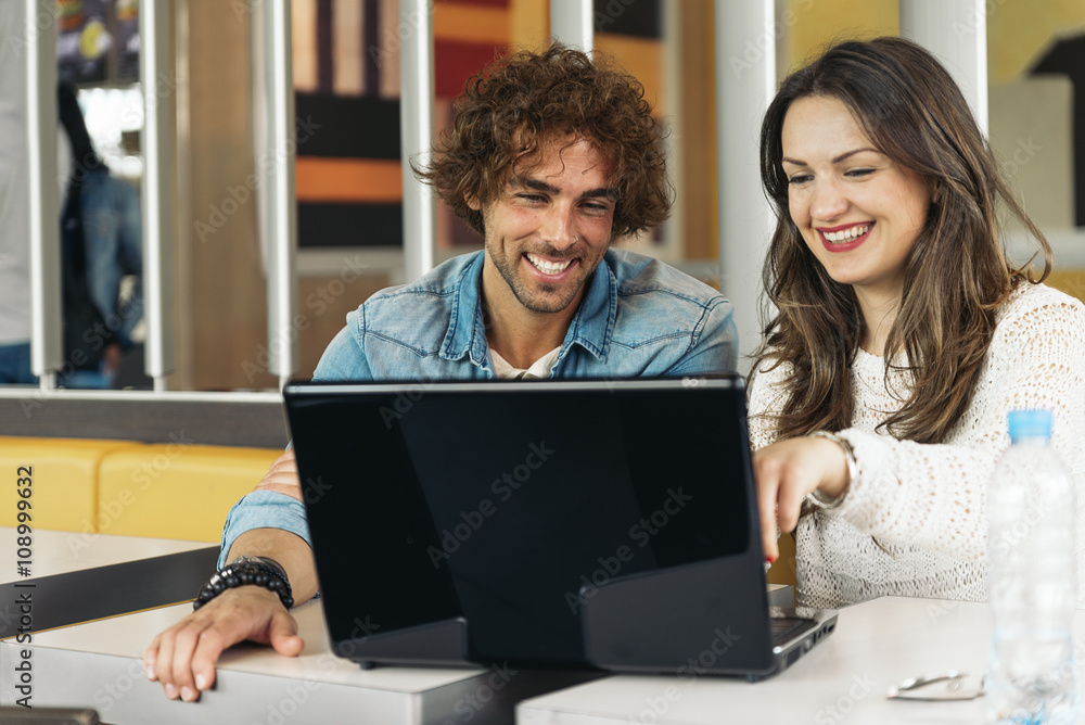 Couple using the laptop in the restaurant while take a lunch. Couple using the laptop in the restaurant while take a lunch.