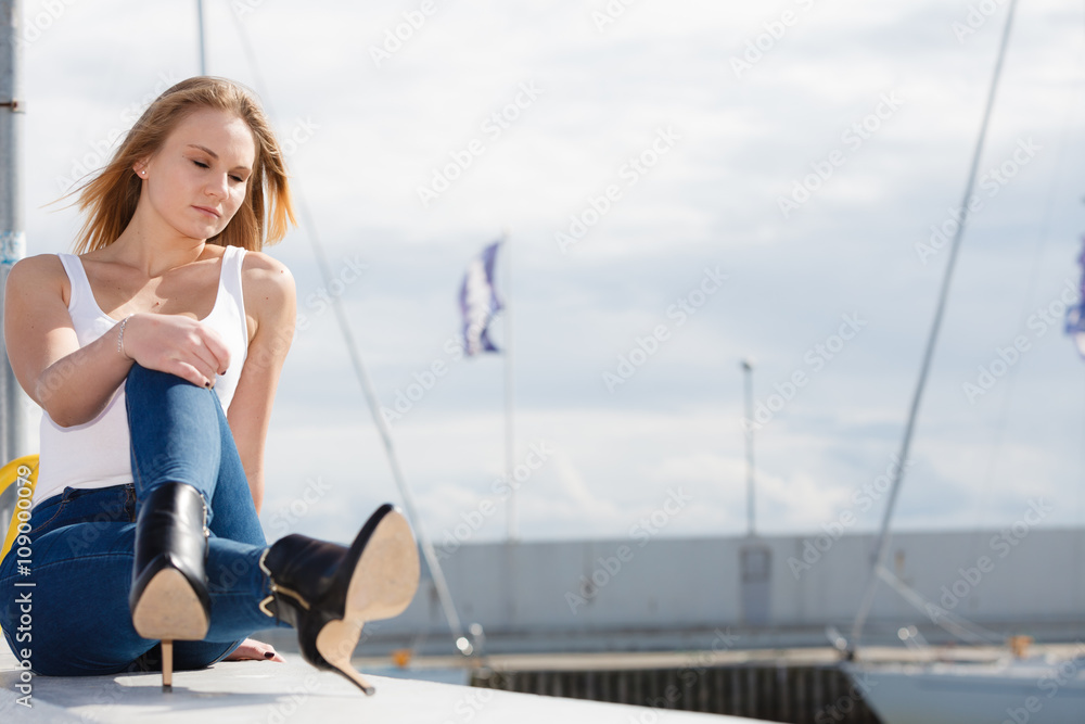 Woman sitting on marina