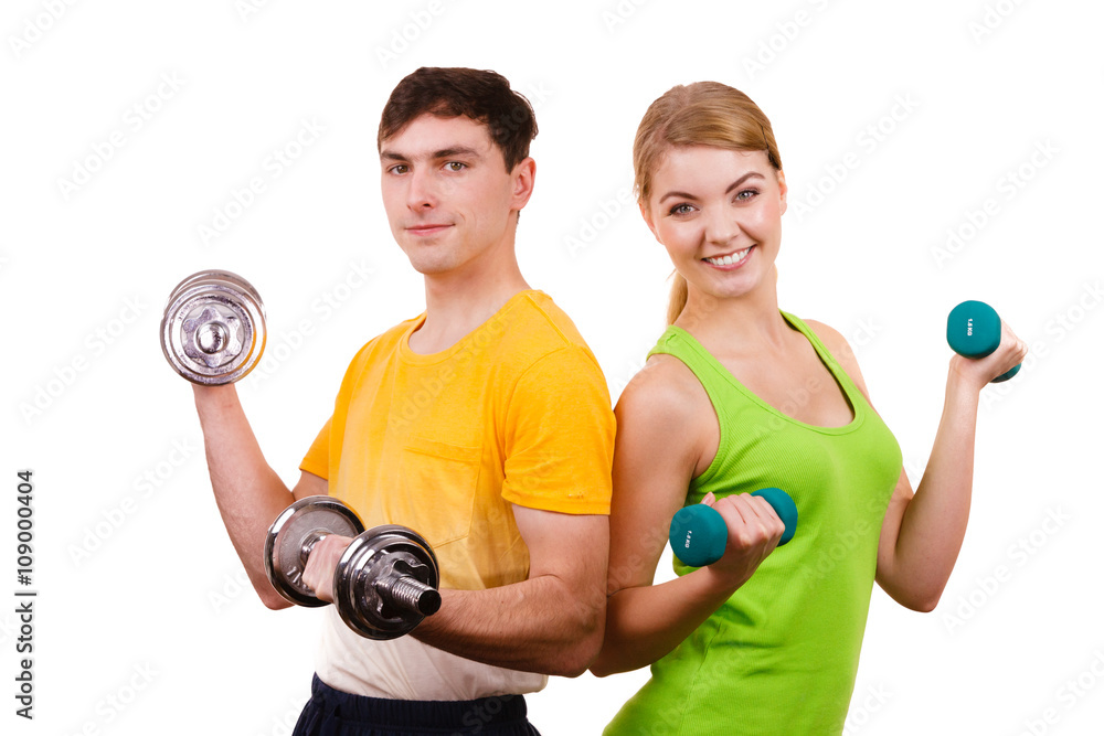 Couple exercising with dumbbells lifting weights Couple exercising with dumbbells lifting weights