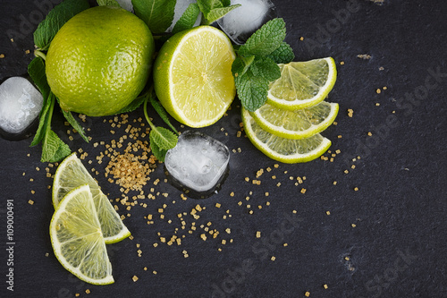 Fresh lime, mint and ice cubes. Dark background